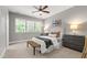 Serene bedroom with large windows, neutral tones, and comfortable furnishings at 7116 Dumfries Ln, Chapel Hill, NC 27514