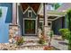 Charming home's front entrance with stone pillars, wooden posts and double glass doors at 7116 Dumfries Ln, Chapel Hill, NC 27514