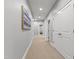 Bright hallway with neutral walls, carpet flooring, and white doors leading to various rooms at 7116 Dumfries Ln, Chapel Hill, NC 27514