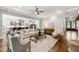 Open-concept living room features hardwood floors and a view of the kitchen at 7116 Dumfries Ln, Chapel Hill, NC 27514
