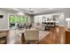 Bright living room with hardwood floors and access to a covered patio and open kitchen at 7116 Dumfries Ln, Chapel Hill, NC 27514