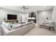 Open-concept living space with sectional, wet bar, TV, and dining area at 7116 Dumfries Ln, Chapel Hill, NC 27514