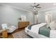 This main bedroom boasts hardwood floors, a ceiling fan, and neutral décor at 7116 Dumfries Ln, Chapel Hill, NC 27514