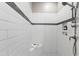 Modern shower with sleek tiling, niche shelving, and a rainfall showerhead at 7116 Dumfries Ln, Chapel Hill, NC 27514
