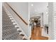 Inviting staircase with patterned carpet runner and wood railing leading to the main level at 7116 Dumfries Ln, Chapel Hill, NC 27514
