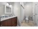 A neutral toned bathroom with a single vanity, tile flooring, a standard toilet, and a shower-tub combination at 75 Stone Hill Ct, Durham, NC 27704