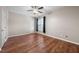 Spacious bedroom with hardwood floors, ceiling fan, and window providing natural light at 75 Stone Hill Ct, Durham, NC 27704