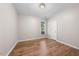 Bright bedroom features hardwood floors, neutral walls, and a window providing natural light at 75 Stone Hill Ct, Durham, NC 27704