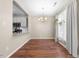 A bright dining area with hardwood floors, a modern chandelier, and plenty of natural light from a nearby window at 75 Stone Hill Ct, Durham, NC 27704
