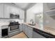 Modern kitchen features stainless steel appliances, light-colored cabinets, and a granite countertop with eat-in breakfast nook at 75 Stone Hill Ct, Durham, NC 27704