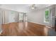 Well-lit living room with hardwood flooring, neutral paint, lots of windows, and direct access to the outside at 75 Stone Hill Ct, Durham, NC 27704