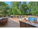Backyard deck featuring patio seating and a grill overlooking a beautiful in-ground pool at 7824 Hemlock Ct, Raleigh, NC 27615
