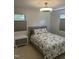 Bedroom featuring a queen size bed with floral bedding, a nightstand, and plenty of natural light at 7824 Hemlock Ct, Raleigh, NC 27615