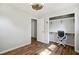 Bedroom featuring hardwood floors, ceiling fan, closet with built-in desk and chair at 7824 Hemlock Ct, Raleigh, NC 27615