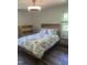 Relaxing bedroom with a wooden bed frame, floral bedding, and coordinating nightstands and dresser at 7824 Hemlock Ct, Raleigh, NC 27615