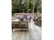 Inviting deck area with comfortable seating, features a view of the sparkling pool and lush greenery, ideal for outdoor living at 7824 Hemlock Ct, Raleigh, NC 27615