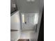 Bright entryway featuring a modern door with sidelights, tile flooring, and a view of the staircase at 7824 Hemlock Ct, Raleigh, NC 27615