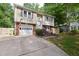 Charming split-level home featuring a brick-accented facade, attached garage, and well-maintained lawn at 7824 Hemlock Ct, Raleigh, NC 27615