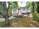 Charming split-level home featuring a brick-accented facade, attached garage, and well-maintained lawn at 7824 Hemlock Ct, Raleigh, NC 27615