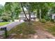 Charming split-level home featuring a brick-accented facade, attached garage, and well-maintained lawn at 7824 Hemlock Ct, Raleigh, NC 27615