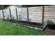 Backyard garden plot with raised bed, orange marigolds, and privacy fence at 7824 Hemlock Ct, Raleigh, NC 27615