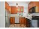 Updated kitchen with modern appliances, light countertops and wood cabinets with views to the backyard at 7824 Hemlock Ct, Raleigh, NC 27615
