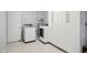 Laundry room with white washer and dryer, lots of cabinet space for storage, and access door at 7824 Hemlock Ct, Raleigh, NC 27615