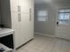 Bright laundry room features a tile floor, ample storage cabinets, and exterior access at 7824 Hemlock Ct, Raleigh, NC 27615