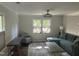 Sunlit living room with modern furnishings, neutral decor, and large windows offering a bright and inviting space at 7824 Hemlock Ct, Raleigh, NC 27615