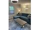 Comfortable living room with a blue sectional sofa, a contemporary coffee table, and ample natural light at 7824 Hemlock Ct, Raleigh, NC 27615
