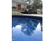 Sparkling pool reflects the sky, surrounded by deck and trees, inviting refreshing swims at 7824 Hemlock Ct, Raleigh, NC 27615