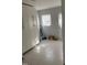 Utility room with tiled floor, built-in cabinets, natural light, and convenient access to the outdoors at 7824 Hemlock Ct, Raleigh, NC 27615