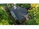 Aerial view showcases this home's screened porch, deck, and surrounding trees, offering privacy and outdoor enjoyment at 905 Neuse Ridge Dr, Clayton, NC 27527