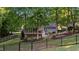 The backyard features a fenced yard, screened porch, deck, mature trees, and decorative landscaping at 905 Neuse Ridge Dr, Clayton, NC 27527