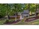 Charming backyard featuring a screened porch, stairs to a deck, mature trees, and tasteful landscaping at 905 Neuse Ridge Dr, Clayton, NC 27527