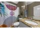 Bathroom with patterned shower curtain and decorative mirror over granite countertop sink at 905 Neuse Ridge Dr, Clayton, NC 27527