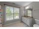 Well-lit bathroom features a vanity with granite countertop and a large window offering plenty of natural light at 905 Neuse Ridge Dr, Clayton, NC 27527