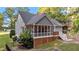 Back exterior showcasing the screened-in porch, with an adjacent deck and a well-maintained lawn at 905 Neuse Ridge Dr, Clayton, NC 27527