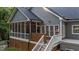 Exterior view of a home with a cozy screened porch, complete with warm lighting and wooden accents at 905 Neuse Ridge Dr, Clayton, NC 27527