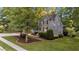Beautifully landscaped yard surrounds this two-story home, showcasing lush greenery and a well-maintained lawn at 905 Neuse Ridge Dr, Clayton, NC 27527