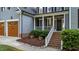 Inviting front entrance with brick steps, white railings, and decorative landscaping at 905 Neuse Ridge Dr, Clayton, NC 27527