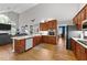 Spacious kitchen with wood cabinets, stainless steel appliances, and an island with a breakfast bar at 905 Neuse Ridge Dr, Clayton, NC 27527