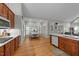Eat-in kitchen with wood floors, white countertops, wooden cabinets, and large windows at 905 Neuse Ridge Dr, Clayton, NC 27527