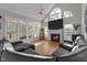 Bright living room featuring large windows, a fireplace, and comfortable seating at 905 Neuse Ridge Dr, Clayton, NC 27527