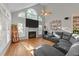 Spacious living area with high ceilings, a fireplace, and a large sectional sofa at 905 Neuse Ridge Dr, Clayton, NC 27527