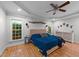 Spacious main bedroom features wood floors, ceiling fan, and natural light from three windows at 905 Neuse Ridge Dr, Clayton, NC 27527