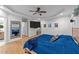 Large main bedroom with wood floors, ceiling fan, tv, and an en-suite bathroom at 905 Neuse Ridge Dr, Clayton, NC 27527