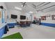 Large recreation room featuring a wet bar with bar stools, multiple TVs, and mini fridge at 905 Neuse Ridge Dr, Clayton, NC 27527