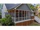 Inviting screened porch with warm lighting and a white railing, perfect for outdoor relaxation and entertaining at 905 Neuse Ridge Dr, Clayton, NC 27527