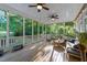 Relaxing screened porch with ceiling fans and comfortable seating surrounded by lush greenery at 905 Neuse Ridge Dr, Clayton, NC 27527